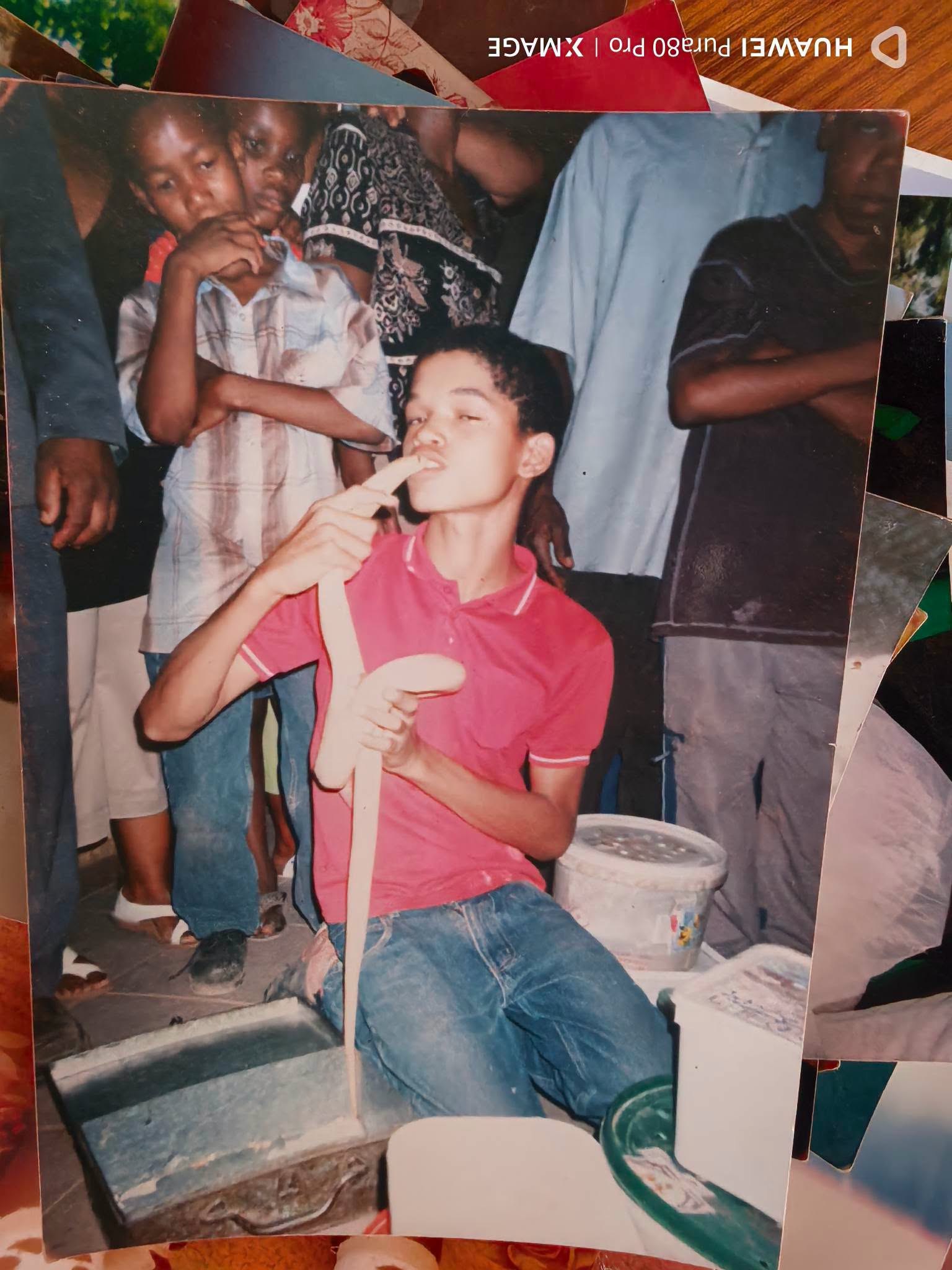 A young Buru with a snake, friends watching